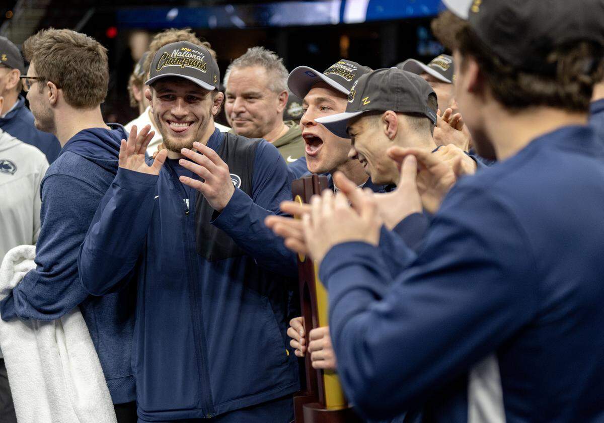 Penn State wrestlers celebrate winning the team title at the  NCAA wrestling championships on Saturday, March 21, 2026.  