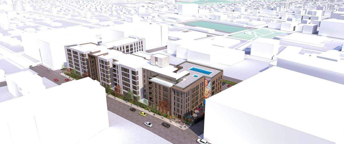 An aerial rendering of what Core Spaces hopes its proposed apartment building will look like at 240 S. Pugh St. The building would replace the Days Inn and other businesses, with construction expected to begin next September.