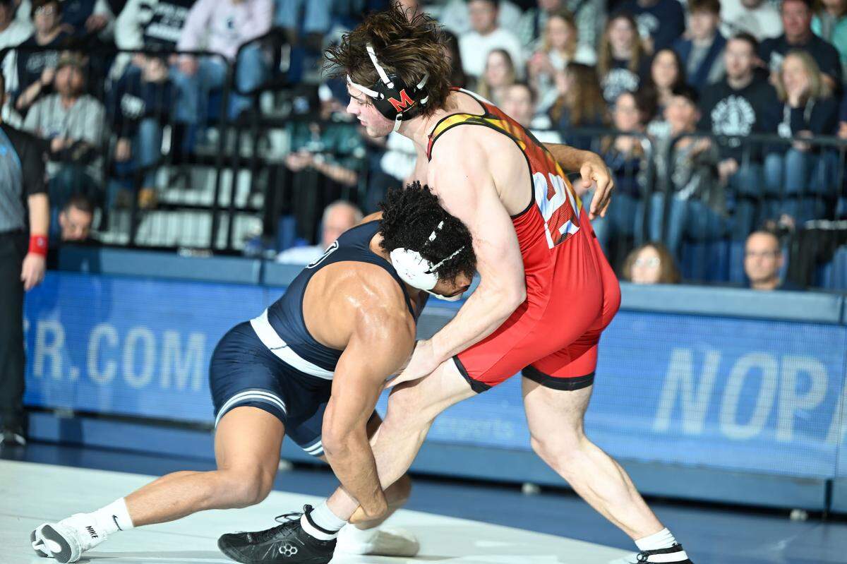 Penn State’s Carter Starocci drives Maryland’s Jaxson Smith to the mat during their 184-lb bout during Sunday’s meeting at Rec Hall in State College. Starocci defeated Smith, 20-3.
