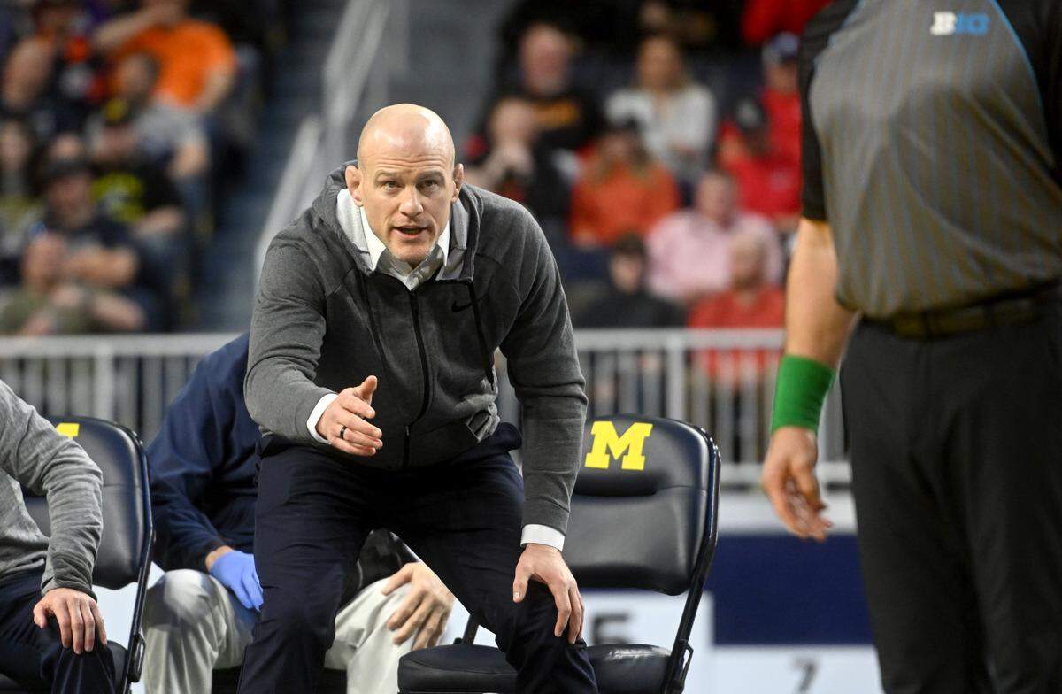 Penn State wrestling coach Cael Sanderson yells to the referee during Roman Bravo-Young’s championship bout of the Big Ten wrestling championships at the Crisler Center on Sunday, March 5, 2023.