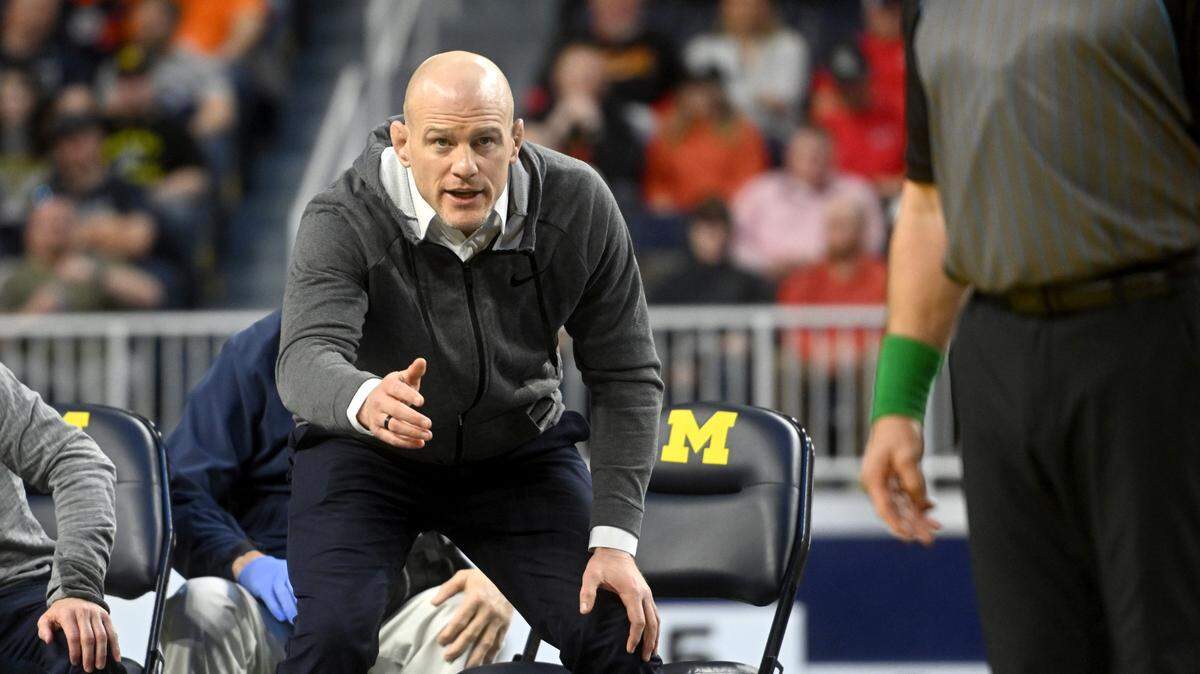 Penn State wrestling coach Cael Sanderson yells to the referee during Roman Bravo-Young’s championship bout of the Big Ten wrestling championships at the Crisler Center on Sunday, March 5, 2023.