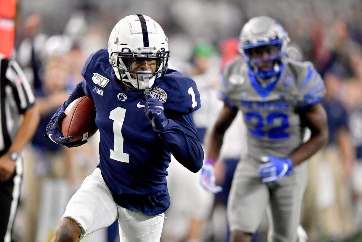 Penn State wide receiver KJ Hamler runs down the field with the ball ahead of Memphis defenders during the 84th Goodyear Cotton Bowl Classic at AT&T Stadium in Arlington, Texas, on Saturday, Dec. 28, 2019.
