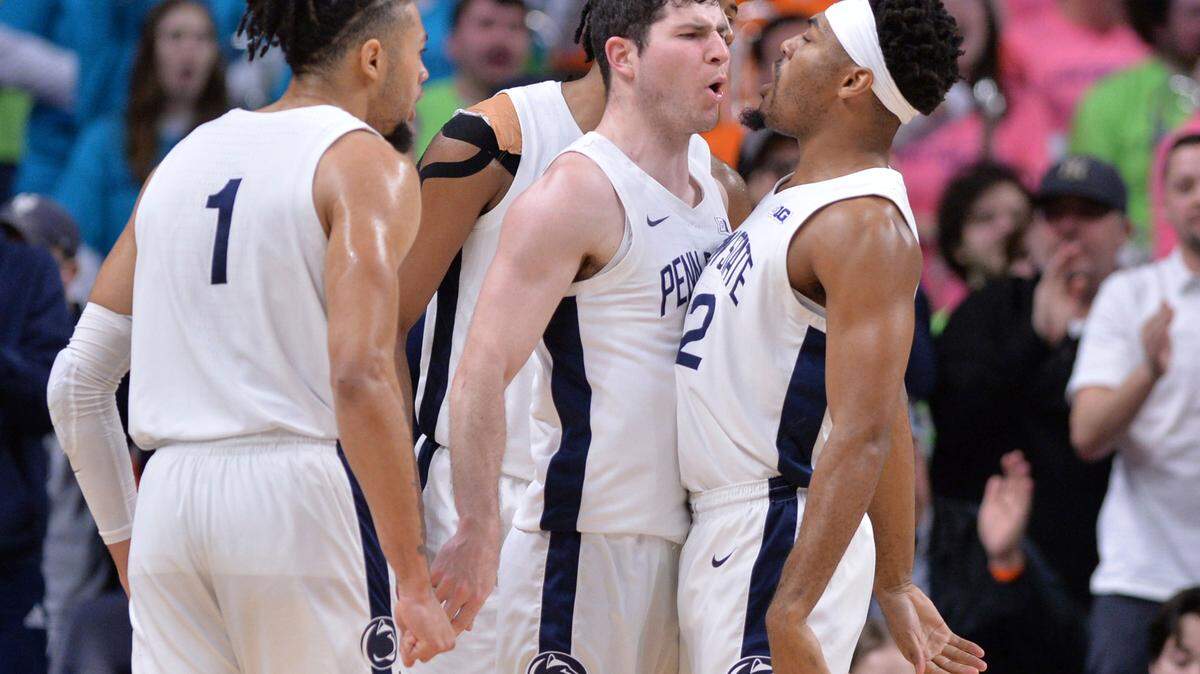Penn State’s Jalen Pickett, right, reacts to a three point shot by Andrew Funk, center during the first half of the Nittany Lions’ game Sunday against Michigan at the Bryce Jordan Center.