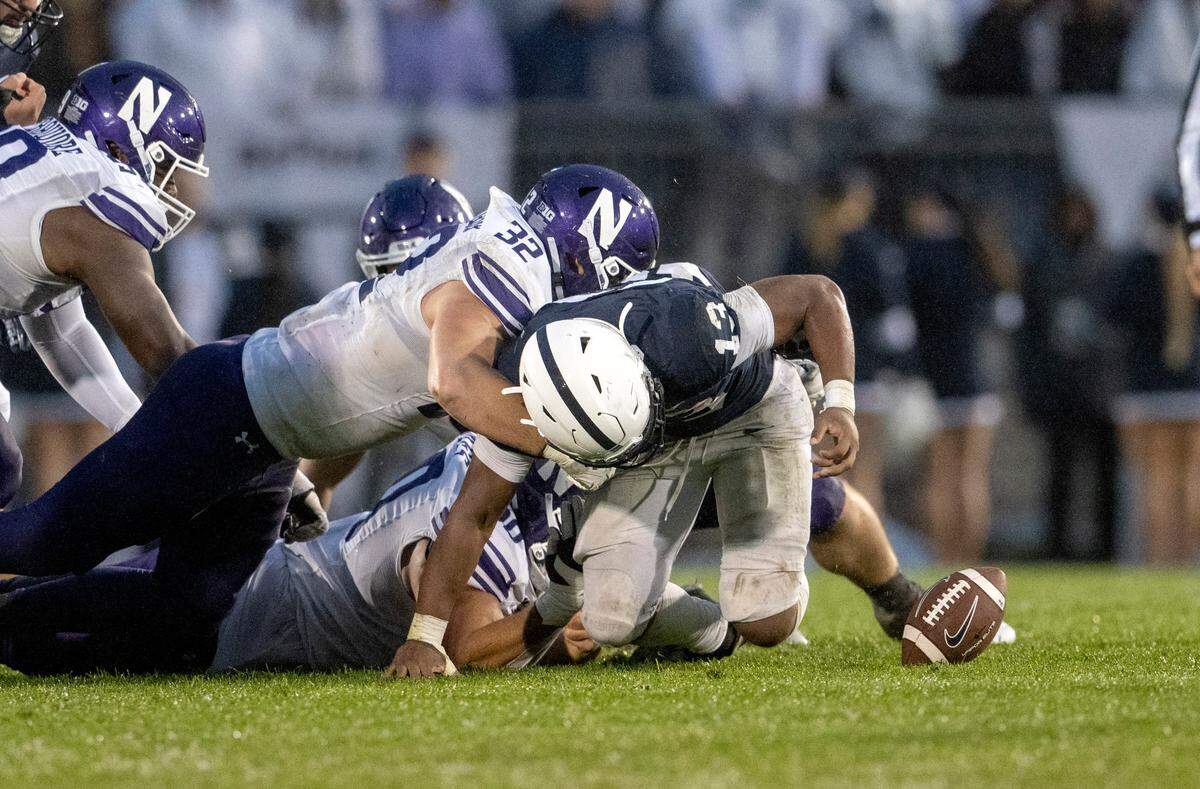 Northwestern defenders cause Penn State running back Kaytron Allen to fumble during the game on Saturday, Oct. 1, 2022.