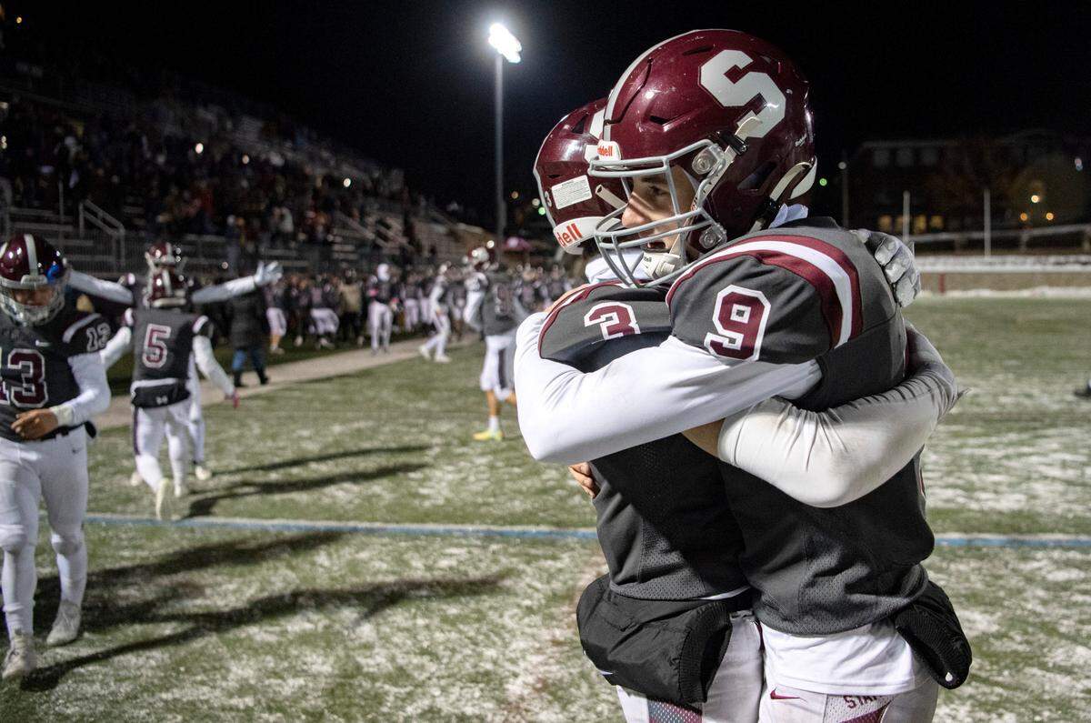 State College’s Ty Salazer and Owen Yerka celebrate after beating McDowell in the third overtime 57-50 on Friday, Nov. 18, 2022.