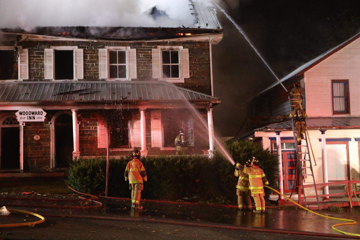 Crews work to extinguish a fire at the Woodward Inn in Haines Township early Sunday morning.