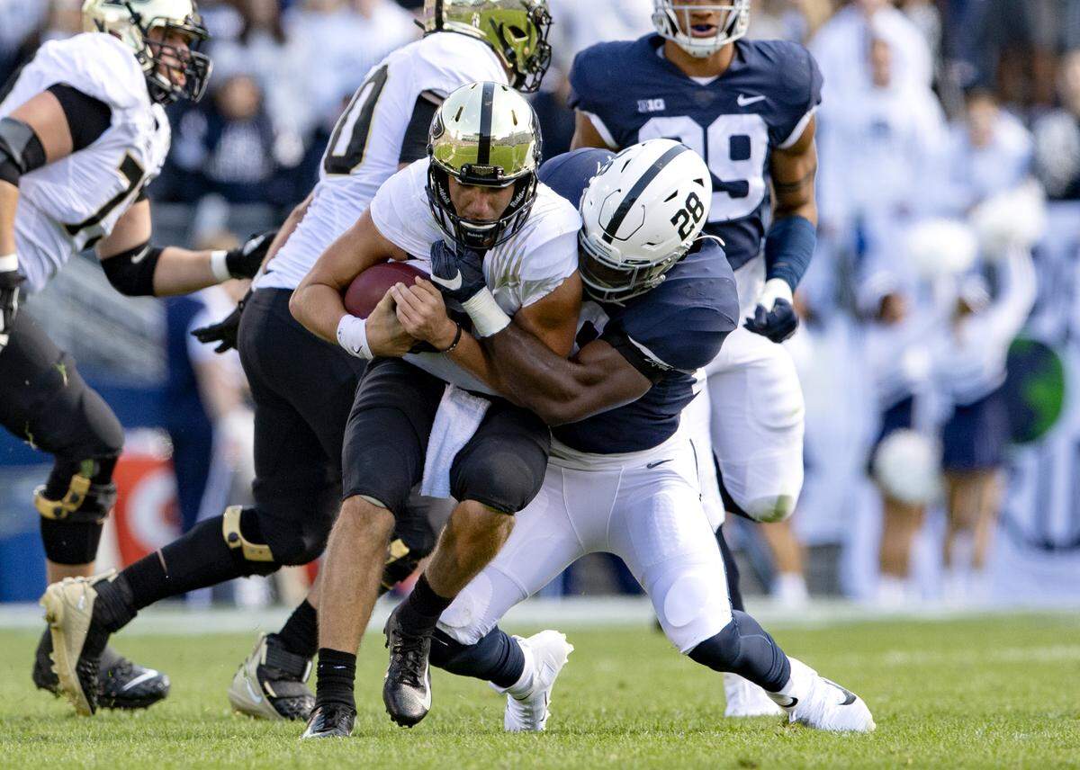 Penn State defensive end Jayson Oweh pulls down Purdue quarterback Jack Plummer during the game on Saturday Oct. 5, 2019.