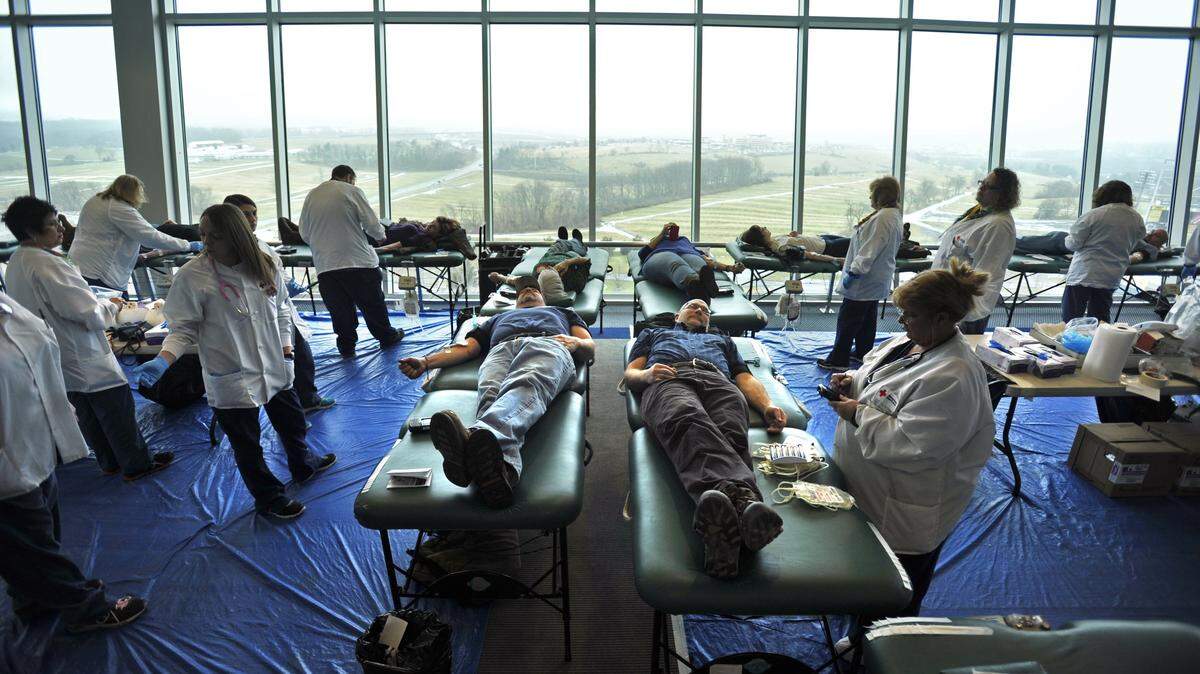 Blood donors participate in a 2014 blood drive in the President’s Suite inside Beaver Stadium hosted by the American Red Cross.