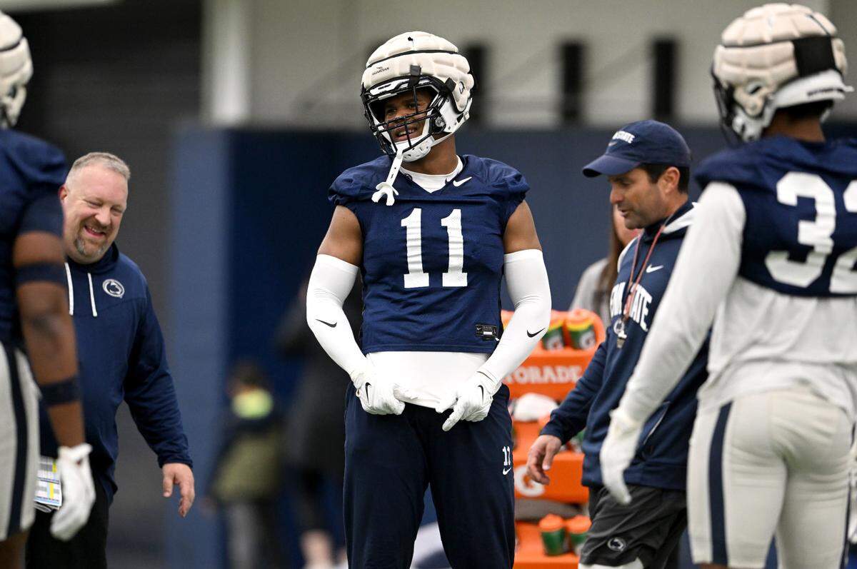 Penn State linebacker Abdul Carter laughs with coaches as they go over a technique during spring practice on Tuesday, March 14, 2023.