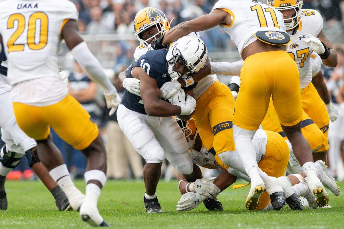 Running back Nick Singleton gets tackled by Kent State players during the football game against Kent State at Beaver Stadium on Saturday, Sept. 21, 2024. Penn State won 56-0.
