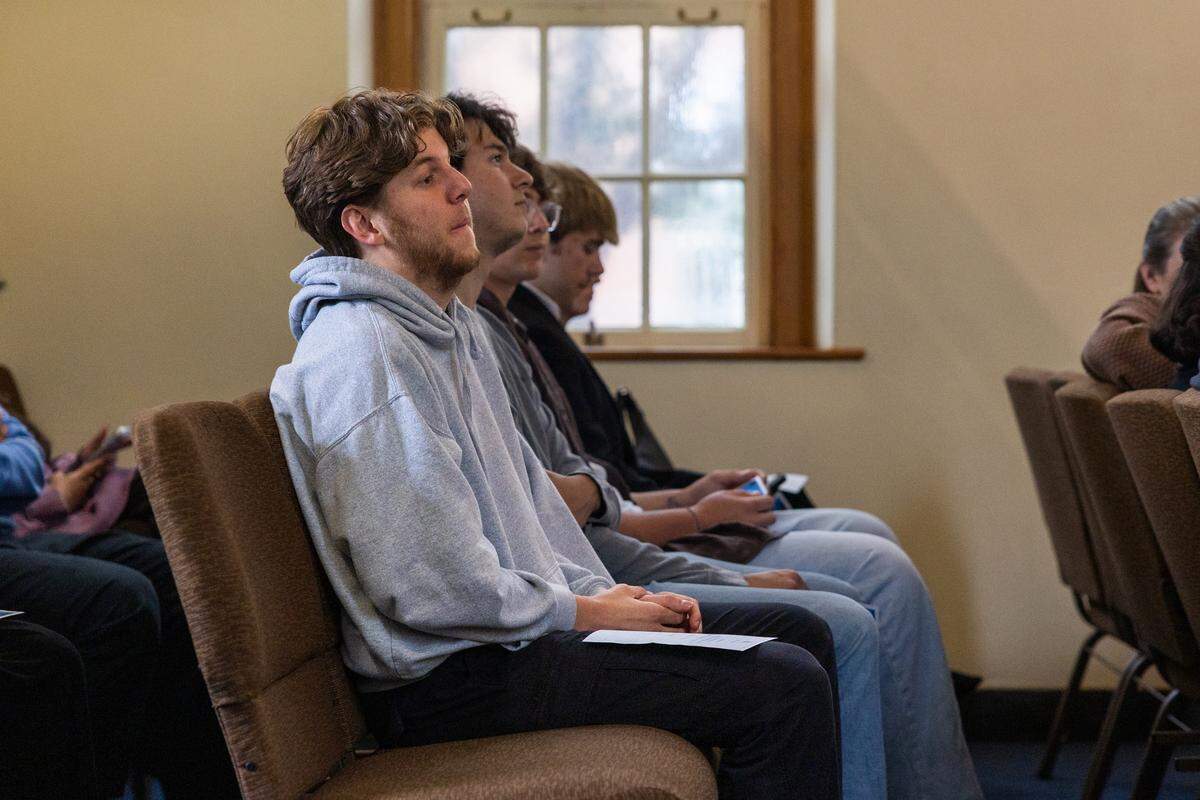 Sam Grant, a fourth-year student studying rehabilitation and human services, sits in the back of Eisenhower Chapel during the Night of Remembrance inside the Pasquerilla Spiritual Center on Thursday, April 30, 2026. The event was hosted by student government organizations in honor of Penn State students and faculty who died during the 2025-26 school year.