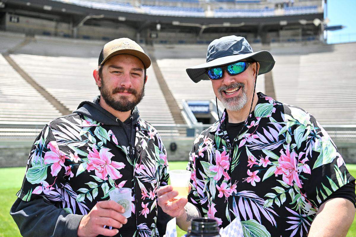 Caleb Johnson, left, and father-in-law Bill Muse pose at the Hoppy Valley Brewers Fest on Saturday at Penn State’s Beaver Stadium.
