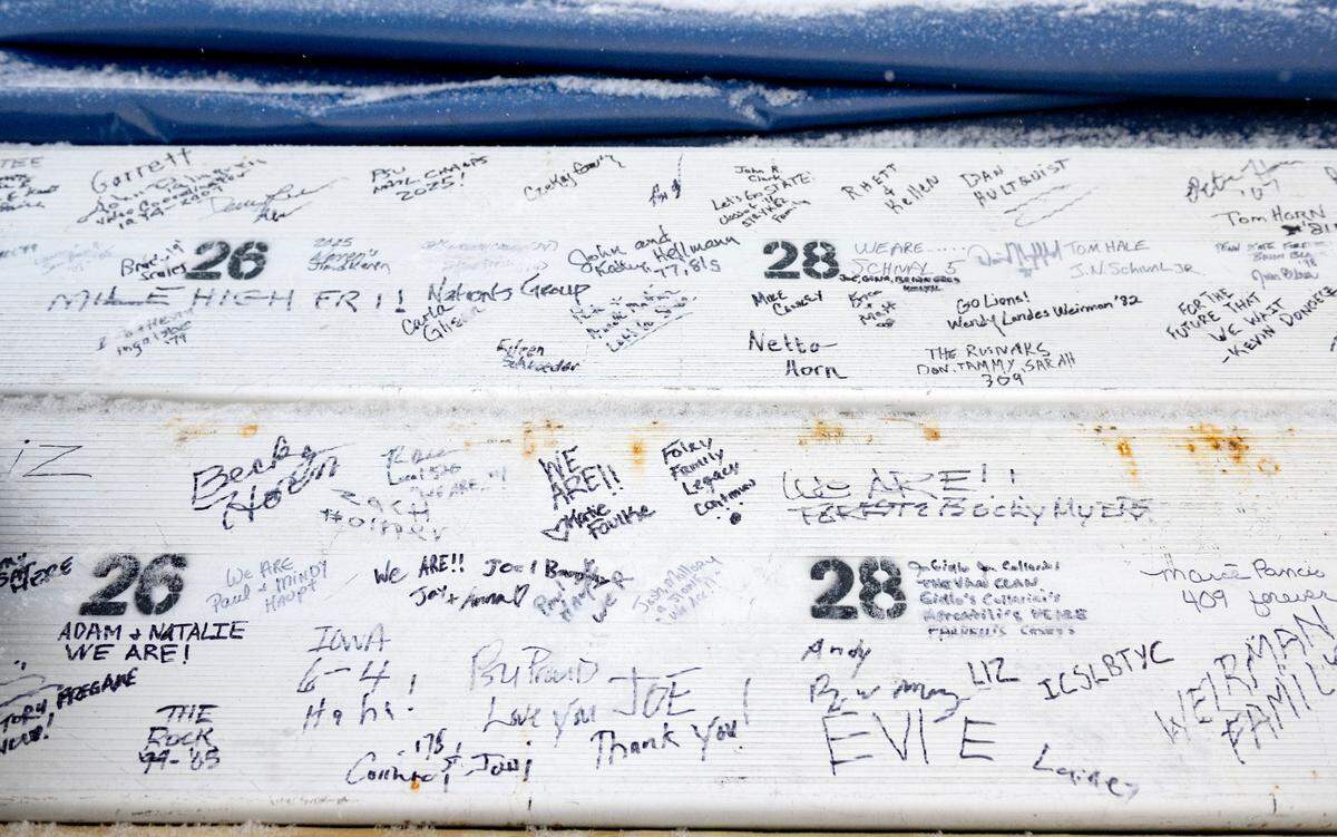Penn State fans sign rows of bleachers from the West side of the stadium after the press box at Beaver Stadium was brought down on Saturday, Jan. 4, 2025.
