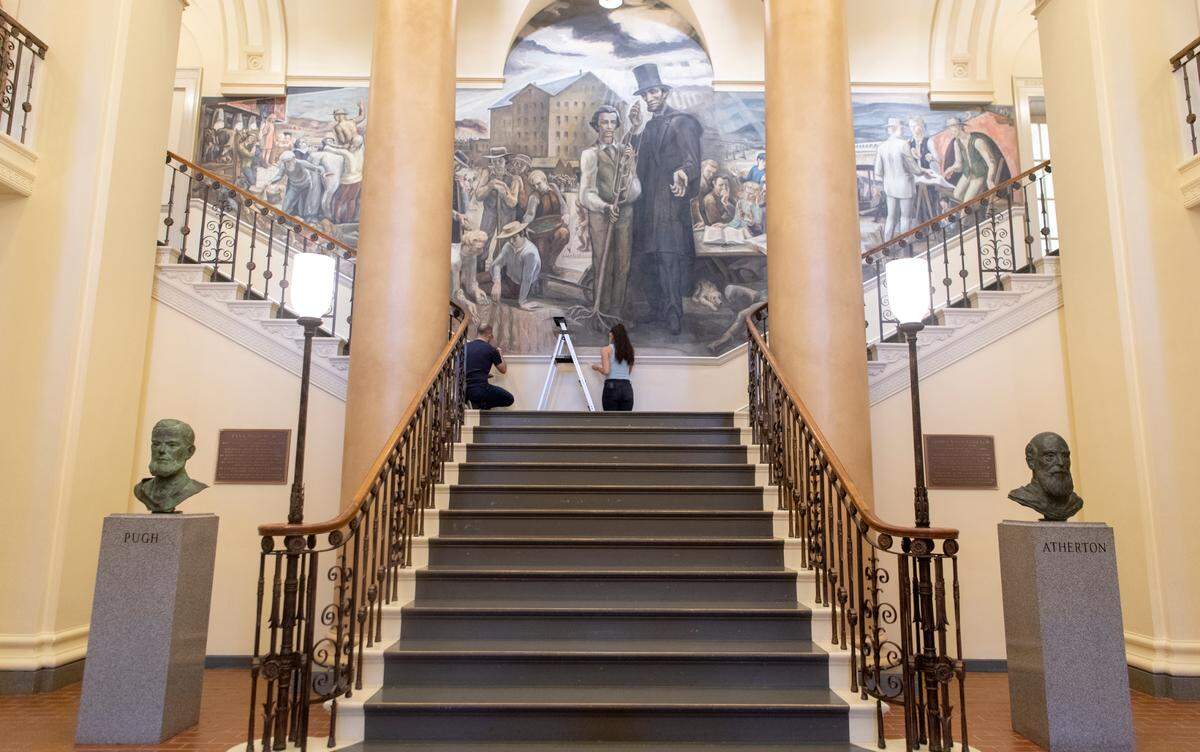 Jeff Johnson and Jacintha Kruc works on frescoes in Old Main on Tuesday, June 14, 2022.