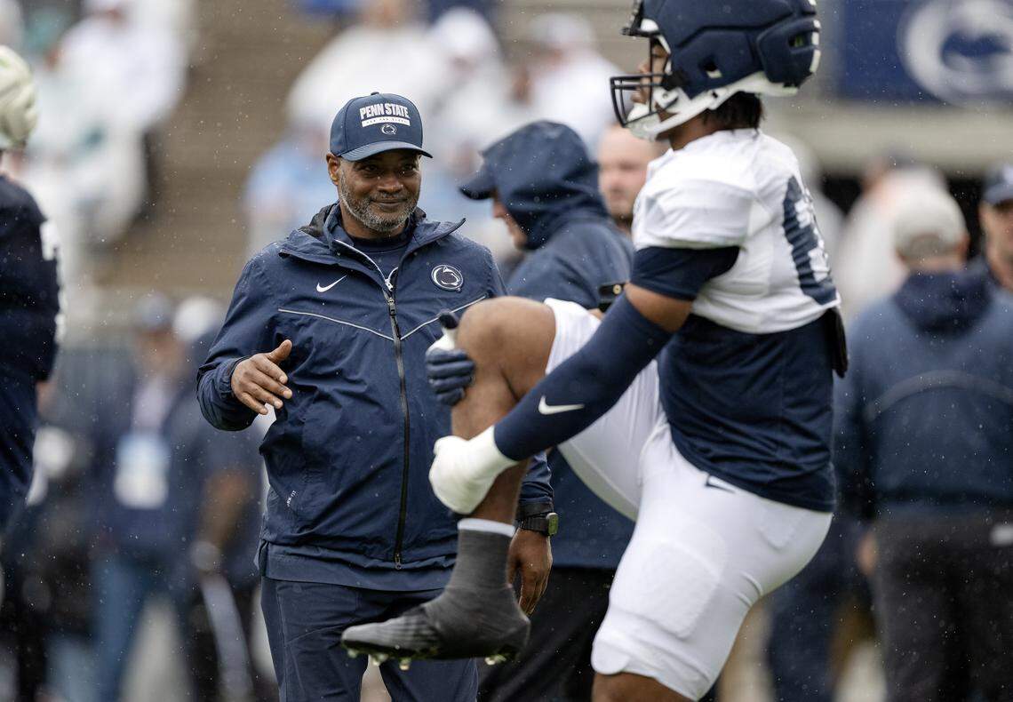 Penn State cornerbacks coach Terry Smith greets players as they stretch for the Blue-White Practice on Saturday, April 25, 2026.  