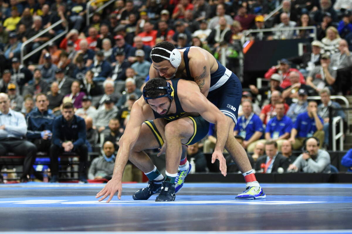 Penn State’s Aaron Brooks aims to keep Michigan’s Myles Amine from escaping in their 184-pound finals match of the NCAA Championships on Saturday, March 19, 2022 at Little Caesars Arena in Detroit. Brooks beat Amine, 5-3, to avenge his Big Ten finals loss and repeat as a NCAA champ.