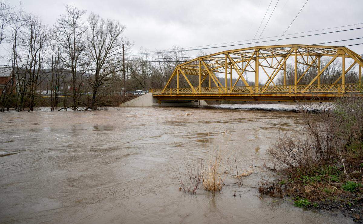 High water rushes under Veterans Bridge in Milesburg on Wednesday, April 3, 2024.