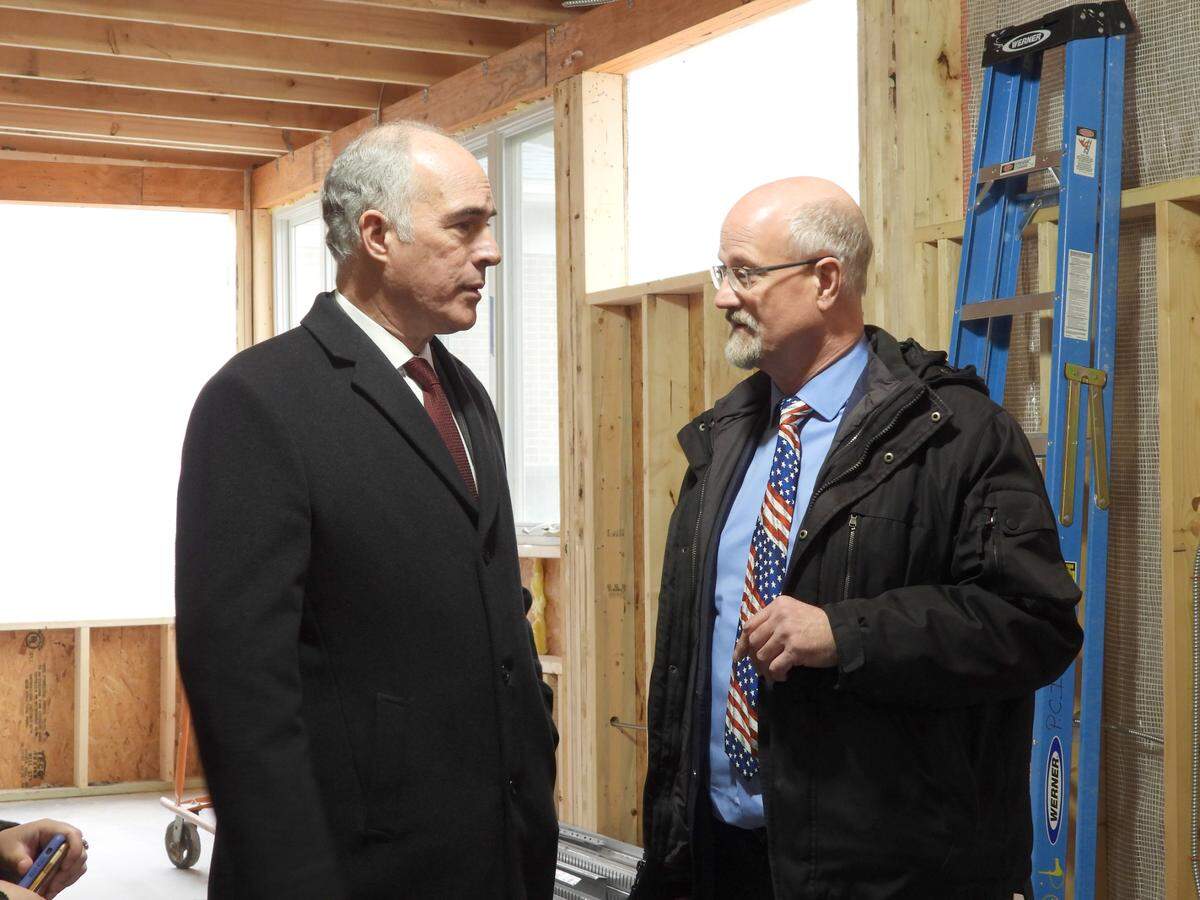 Pennsylvania Senator Bob Casey, left, talks with Centre County Commissioner Mark Higgins at the new Centre Volunteers in Medicine building Tuesday. Casey secured $1.1 million in federal funding for the nonprofit.