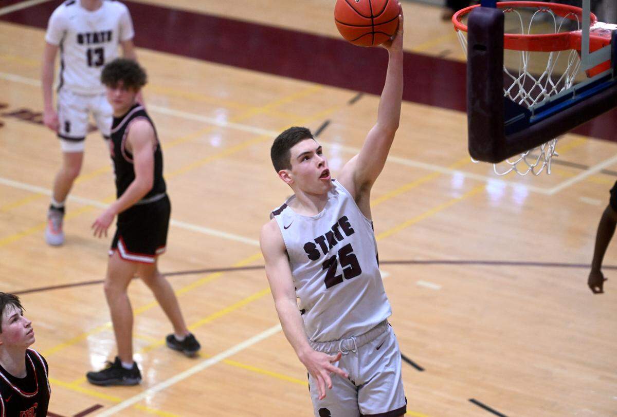 State College’s Isaac Dye goes in for a basketball during the PIAA first round game against Upper St. Clair on Saturday, March 11, 2023. State College won, 72-42.