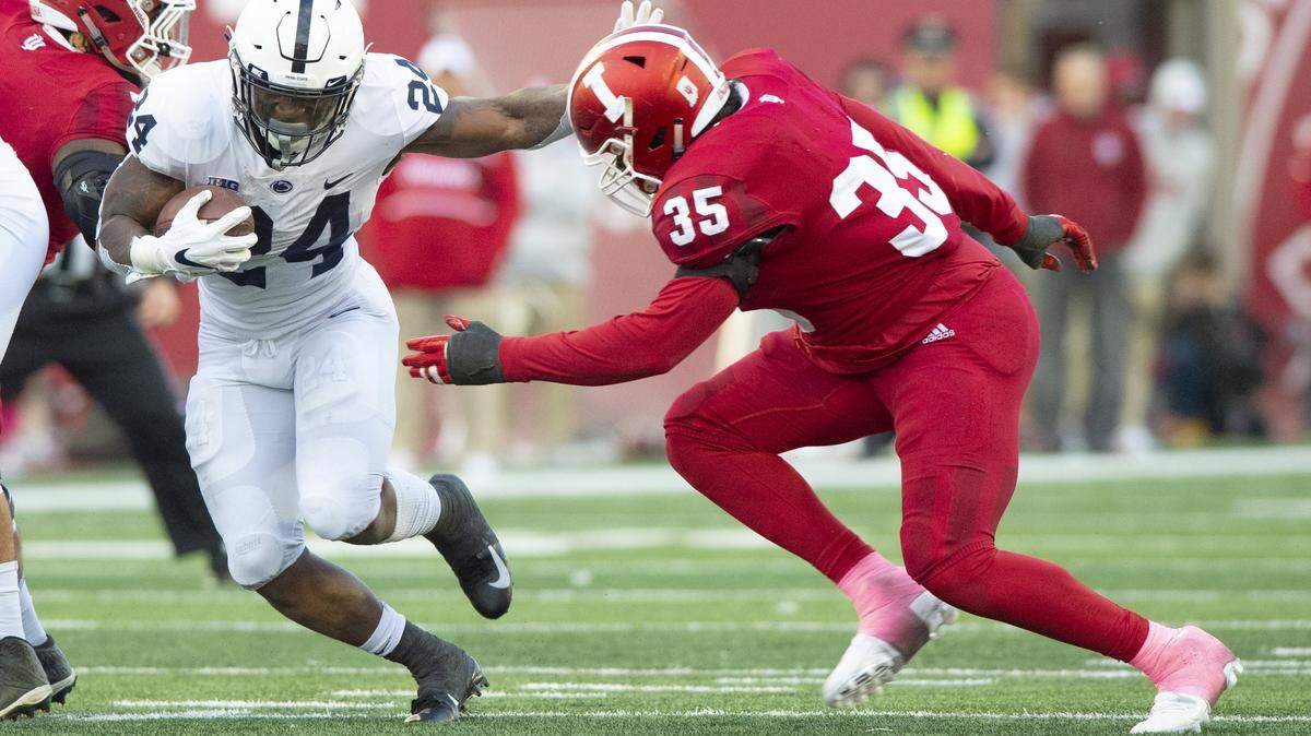 Penn State running back Miles Sanders (24) rushes the ball out of the backfield as he’s pursued by Indiana defensive lineman Nile Sykes (35) during the second half of an NCAA college football game Saturday, Oct. 20, 2018, in Bloomington, Ind. Penn State won 33-28. (AP Photo/Doug McSchooler)