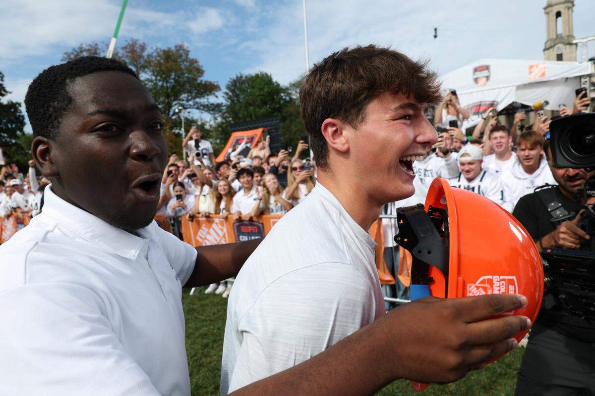 Penn State student Carson Albright, right, and fellow student William react Saturday morning after Albright nailed a 33-yard field goal to win them each $150,000, or 300K total, during the Field Goal Kicking Challenge segment on the set of College GameDay at Penn State.