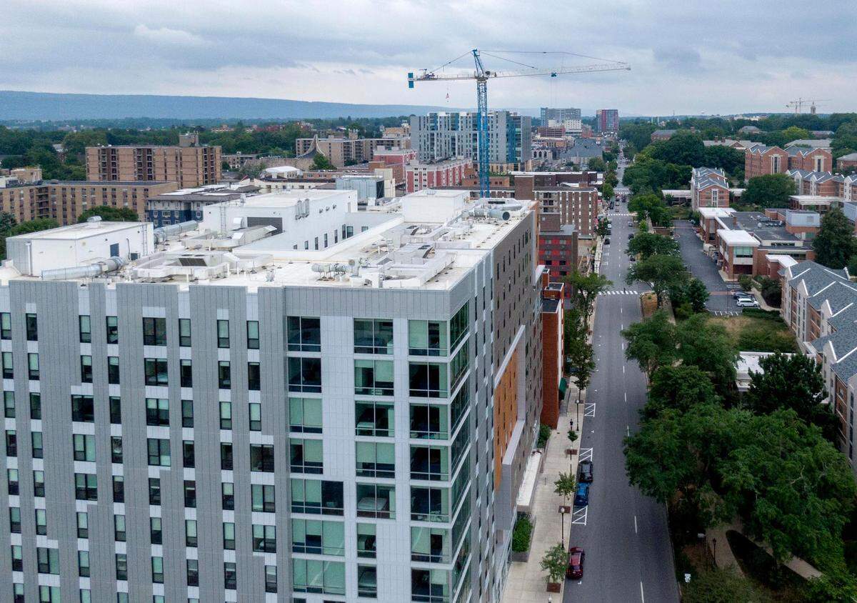 Above is an aerial look at some of the high-rises and construction for a new building on the east end of downtown State College on Wednesday, July 27, 2022.