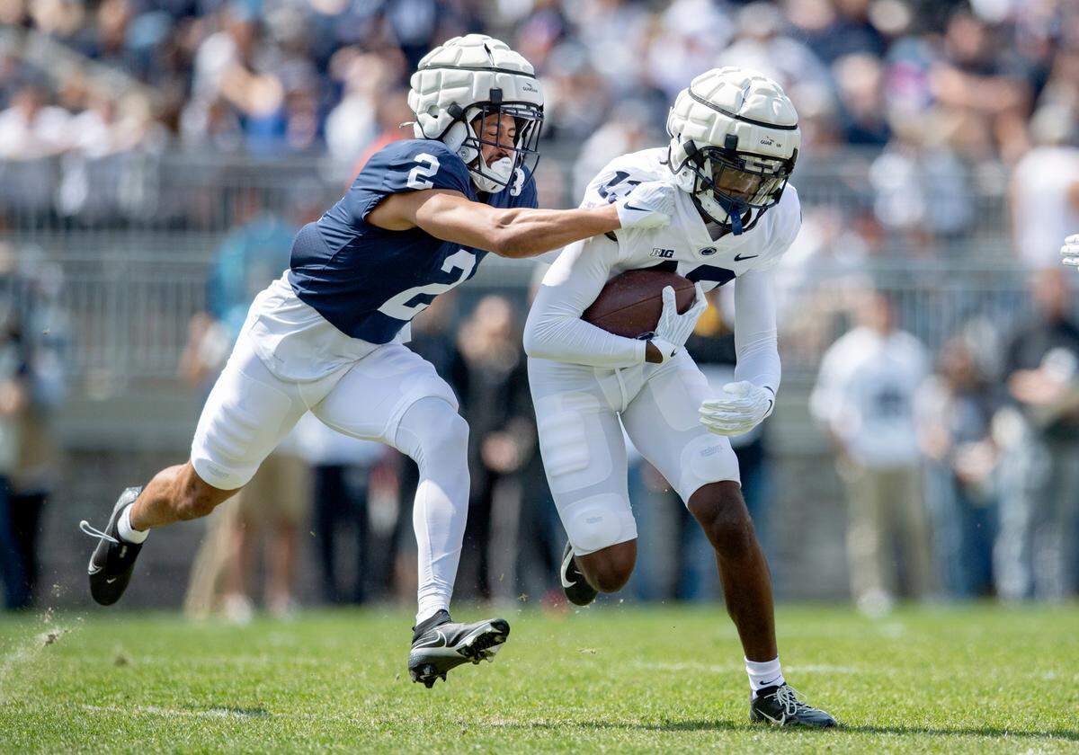 Penn State safety Keaton Ellis tries to stop Penn State wide receiver KeAndre Lambert-Smith as he runs with the ball during the Blue-White game on Saturday, April 23, 2022.
