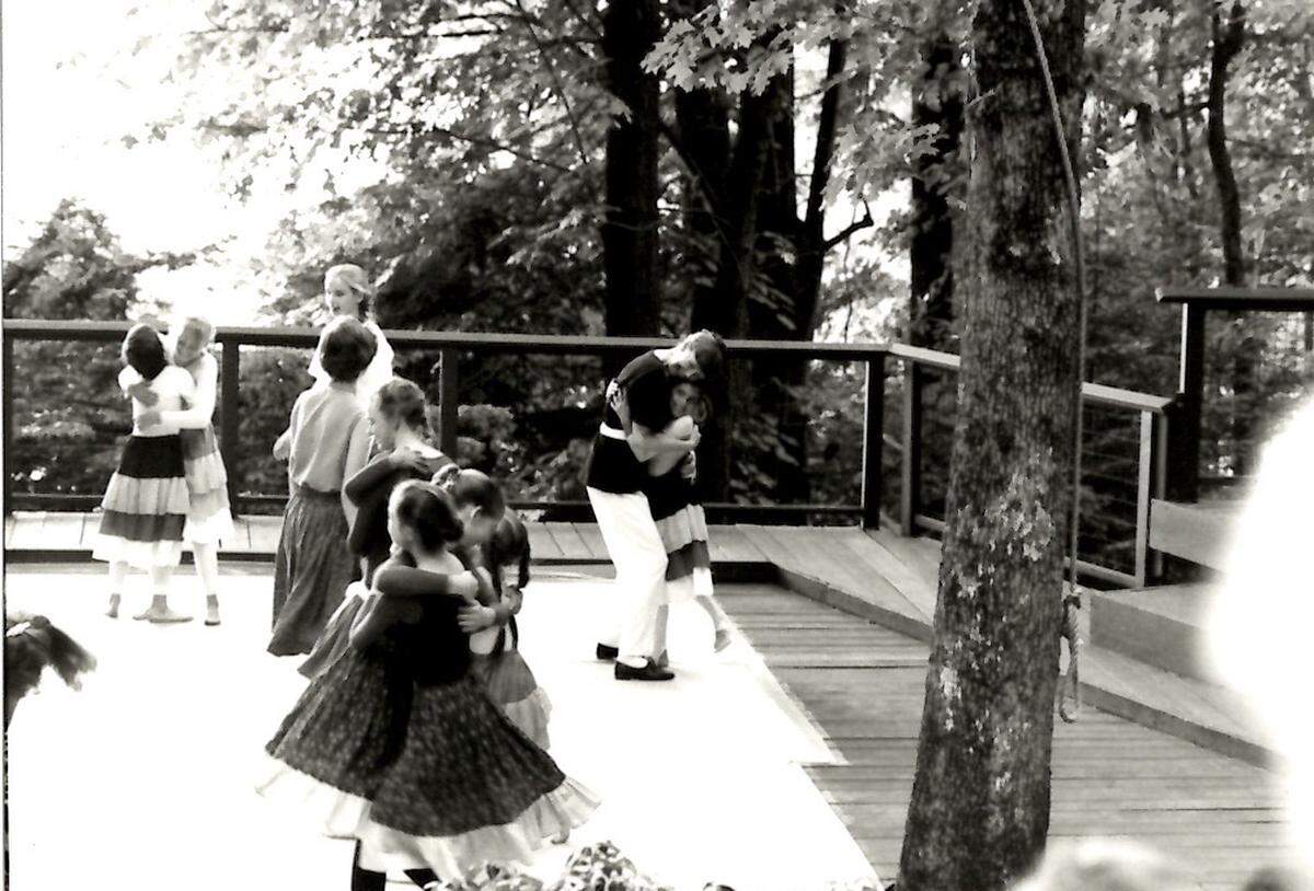 Betty Jane Dittmar and Loren Groenendaal hug on the Strawberry Hill dance deck after completing the intergenerational folk dance called the “Swing Walk.”