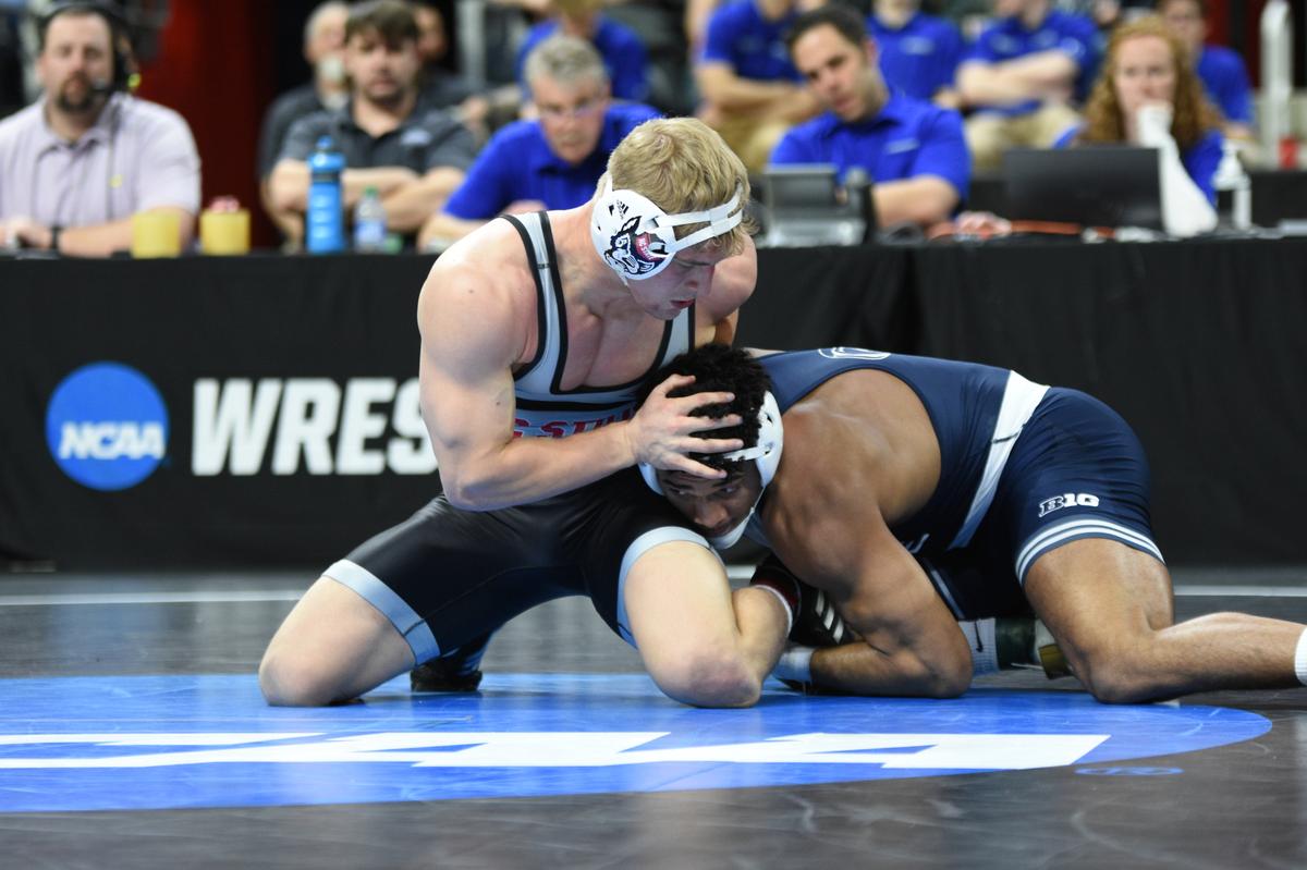 Penn State’s Carter Starocci aims to finish off a takedown of North Carolina State’s Hayden Hidlay in their 174-pound semifinals match of the NCAA Championships on Friday, March 18, 2022 at Little Caesars Arena in Detroit. Starocci cruised past Hidlay, 10-3.
