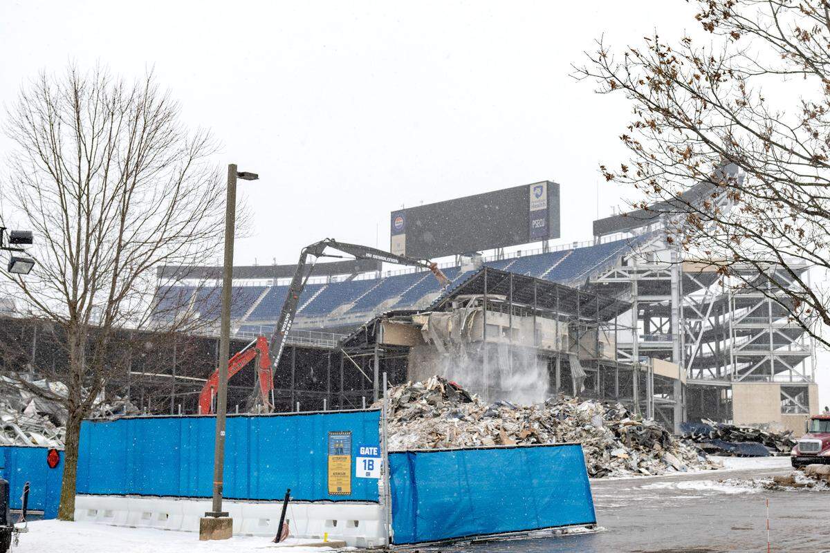 Crews work in the snow on the demolition of the west side of Beaver Stadium on Wednesday, Jan. 8, 2025.