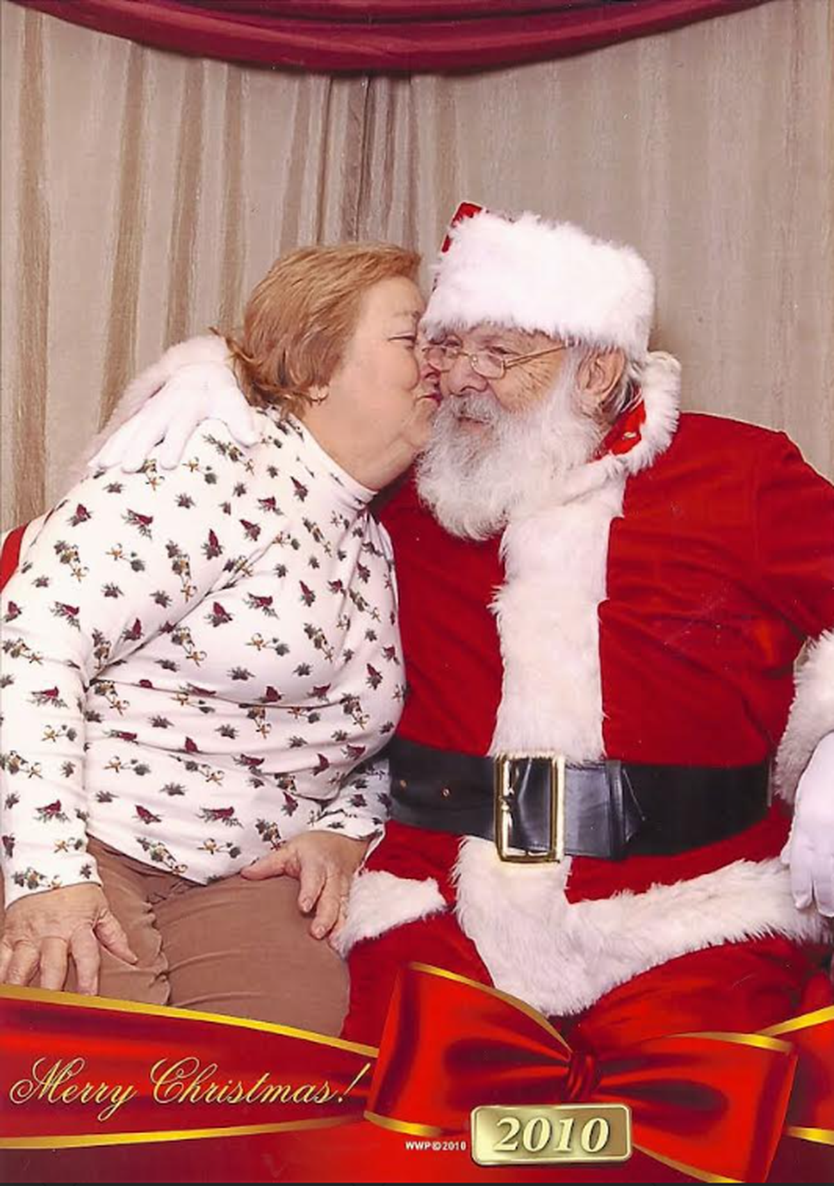 Chuck Mong is pictured in 2012 dressed up as Santa Claus, kissing his late wife Irene on the cheek.