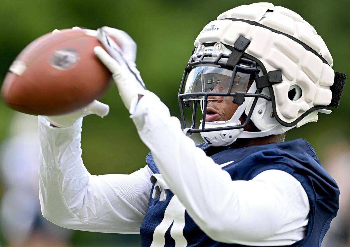 Penn State cornerback Kalen King catches a ball off the jugs machine during the first day of practice on Monday, Aug. 1, 2022.