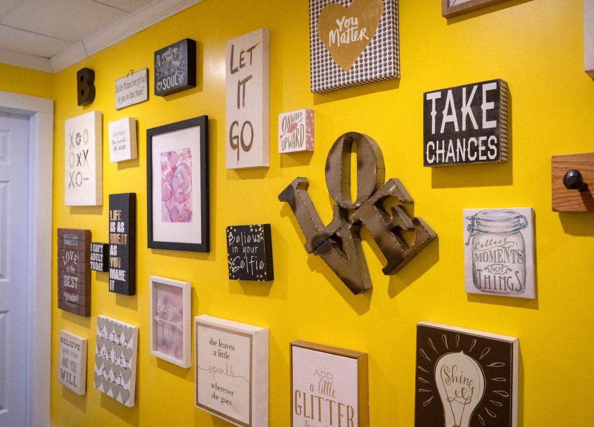 A yellow wall full of fun and inspirational signs at the Blonde Bistro Brew Works at 226 Nittany Valley Drive in Zion.