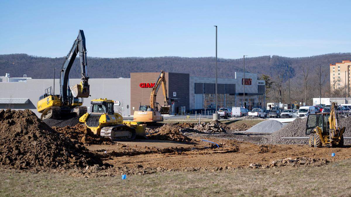 A construction crew works along Benner Pike at the Paradise Shopping Center on Benner Pike on Tuesday, Feb. 6, 2024. 