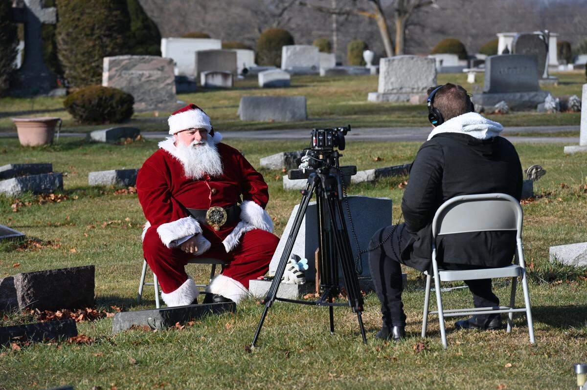 Director Spencer Folmar interviews Allen Smith at the grave of his 23-year-old son, Garrett for an upcoming documentary about Smith’s life and work as Santa’s Helper.