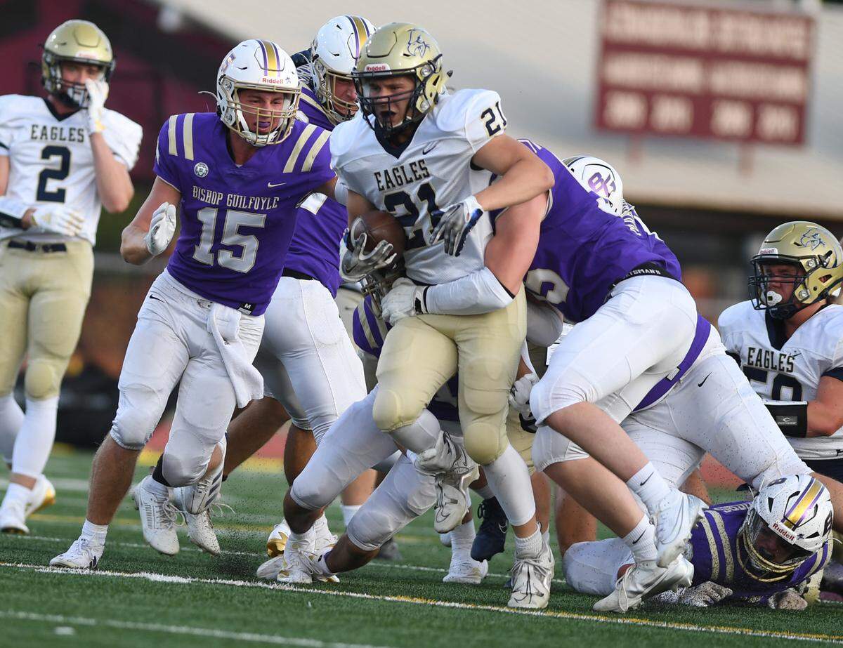 Bald Eagle Area’s Blake Houk-Leitzell (21) goes up the middle before being brought down by the Bishop Guilfoyle defense in the second quarter Saturday at Altoona’s Mansion Park.