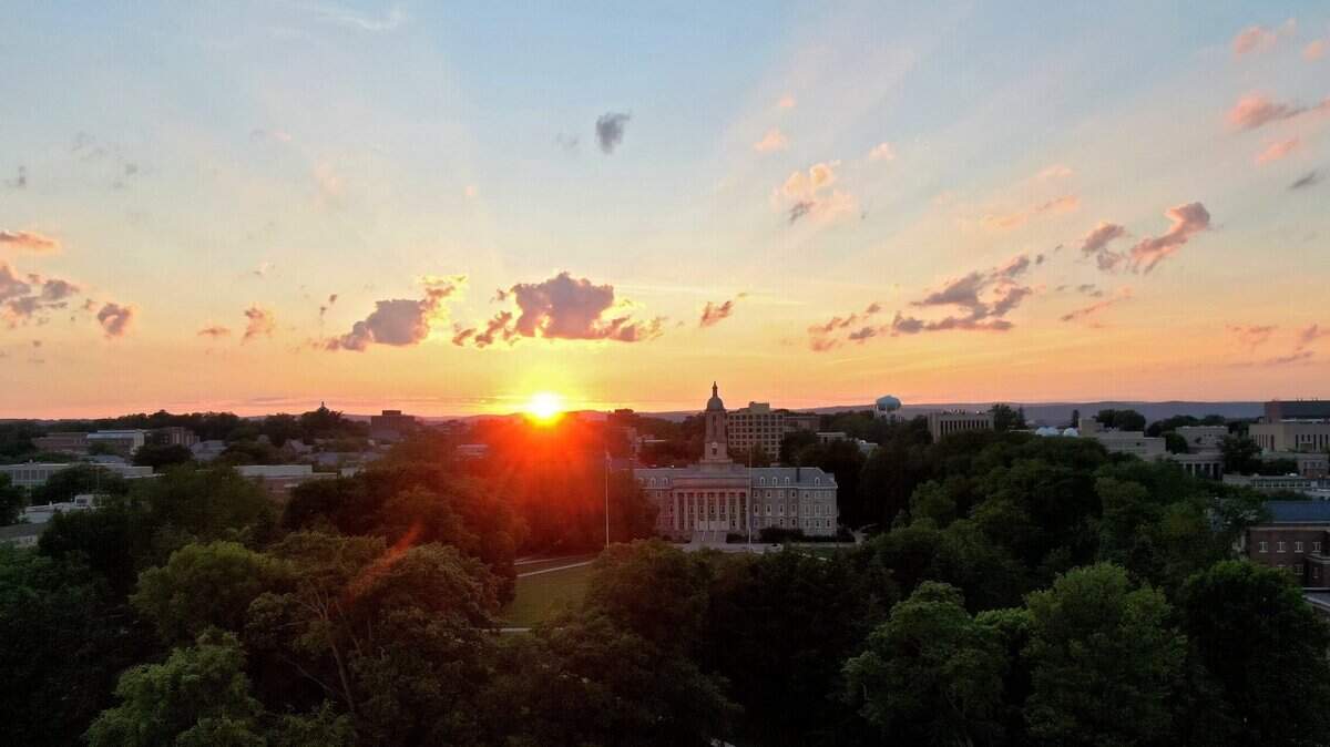 The sun sets over Old Main and the Penn State University Park campus on Sunday, June 27, 2021.