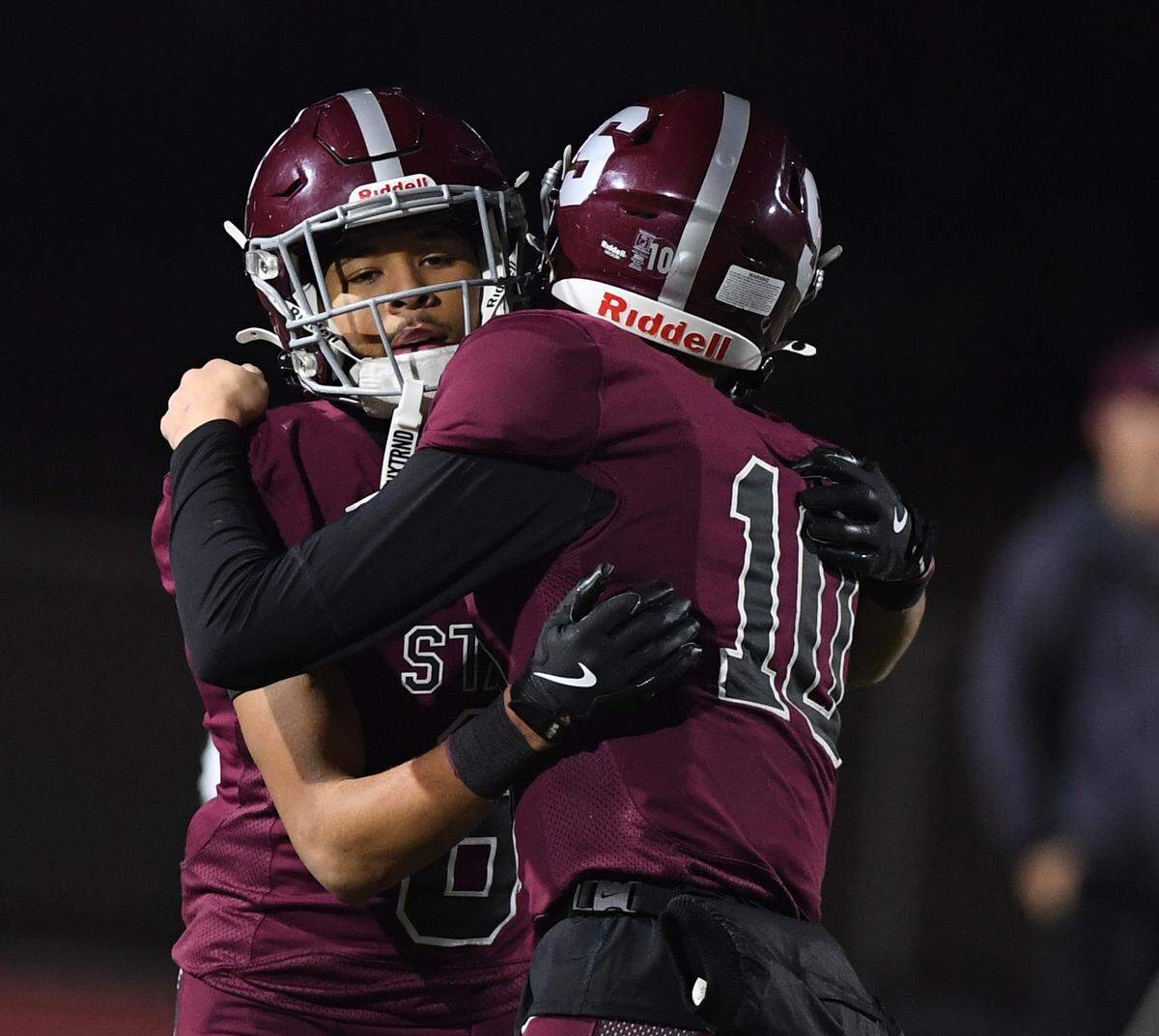 State College quarterback Connor Kulka, right, congratulates teammate Daimear Coad after Coad made a 69 yard reception/run to score in fourth quarter action against Central Catholic in a PIAA Class 6A quarterfinal game Friday, Nov. 21, 2025 at Altoona’s Mansion Park.