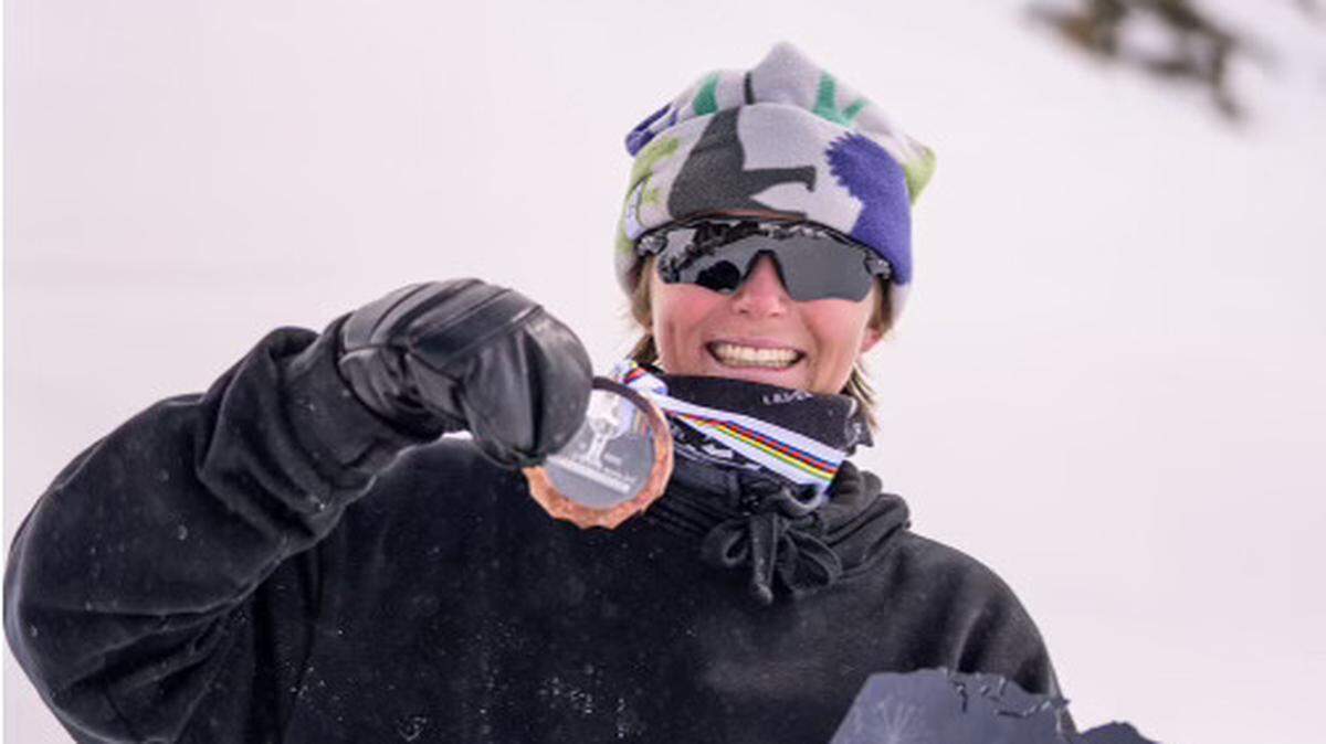 Jay Riccomini holds up a medal.