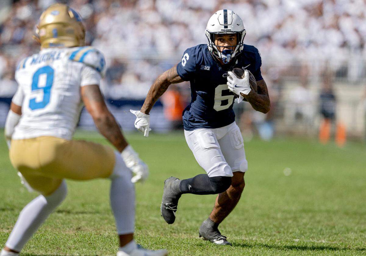 Penn State wide receiver Tre Wallace cuts down the field with the ball from a UCLA defender on Saturday, Oct. 5, 2024 at Beaver Stadium.