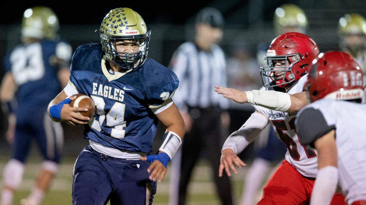 Bald Eagle Area’s Tre Greene runs down the field with the ball around Purchase Line defenders during the game on Friday, Oct. 28, 2022.
