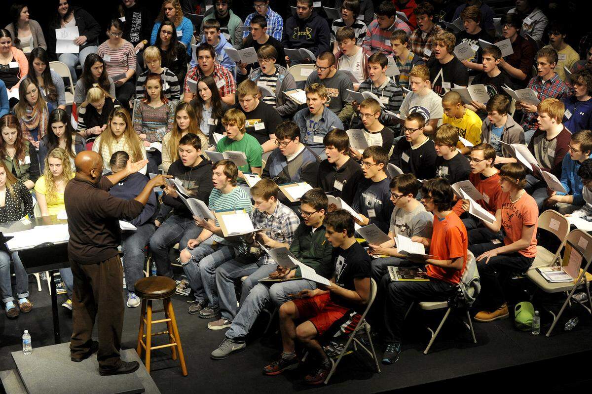 Anthony Leach, a professor of music at Penn State, directs the PMEA District 4 Chorus at Bellefonte Area High School on Thursday, January 9, 2014.