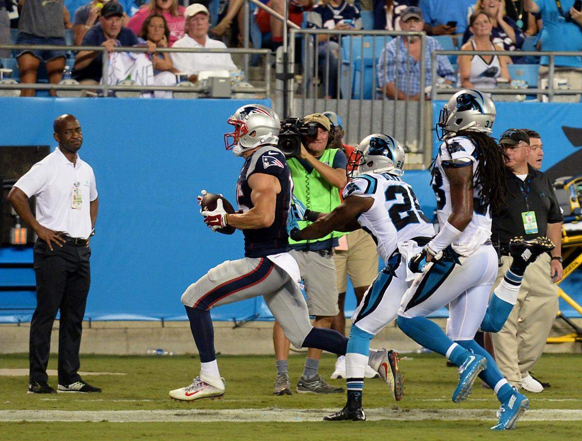 New England Patriots wide receiver Chris Hogan, left, races into the end zone following a pass reception from quarterback Tom Brady during second quarter action vs the Carolina Panthers at Bank of America Stadium on Friday, August 26, 2016.