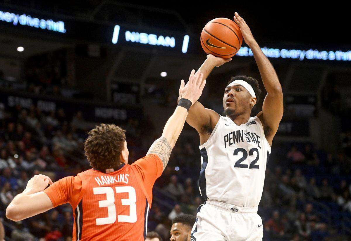 Penn State’s Jalen Pickett shoots for a basket over Illinois Coleman Hawkins during the game on Tuesday, Feb. 14, 2023.