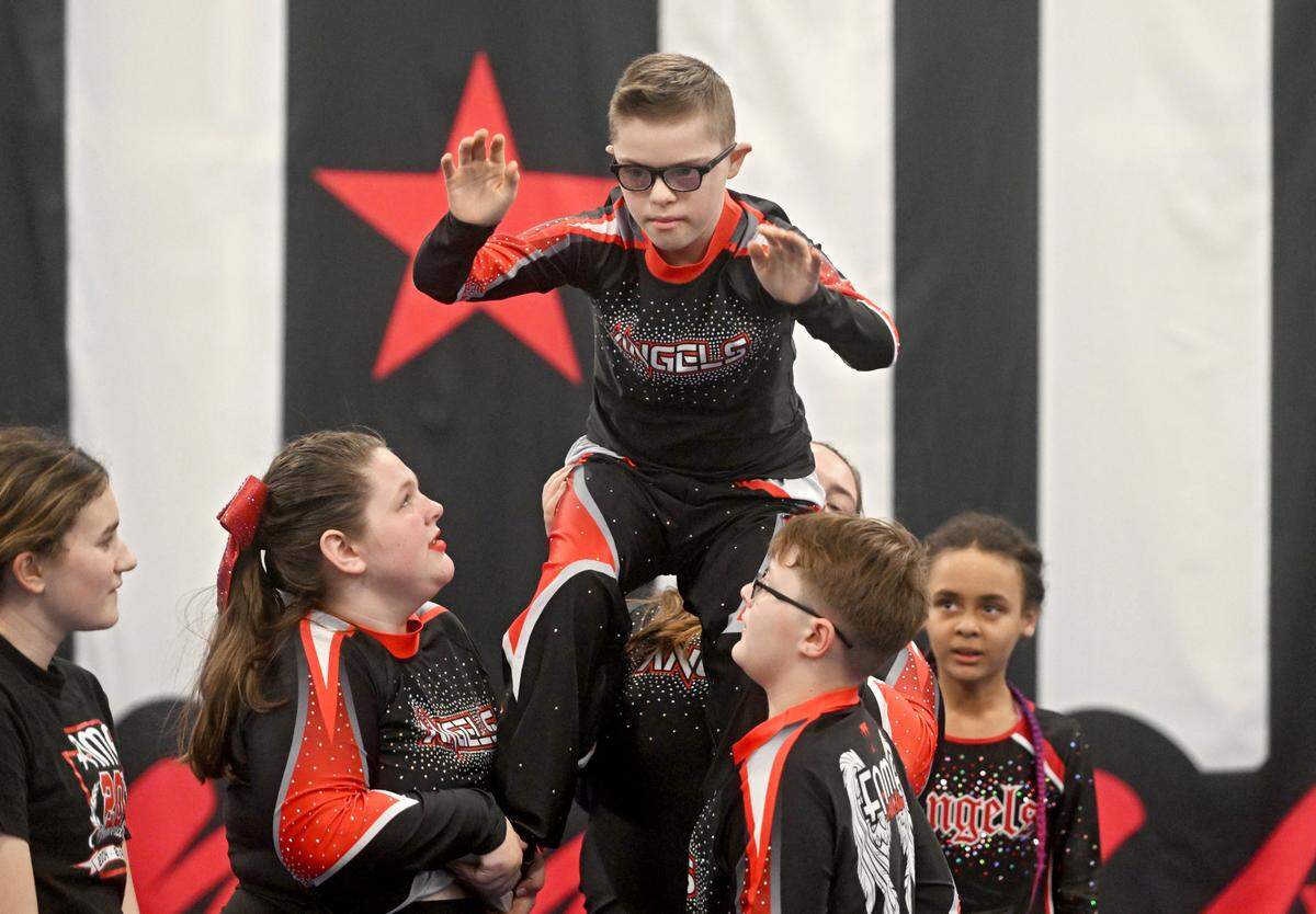 Daniel Workman gets lifted by his teammates as the Fame Angels practice their routine on Tuesday, March 12, 2024.