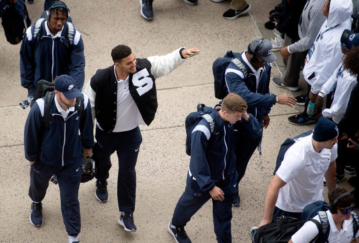 Penn State football players wave to fans as they arrive at Beaver Stadium for the game on Saturday, Oct. 1, 2022.
