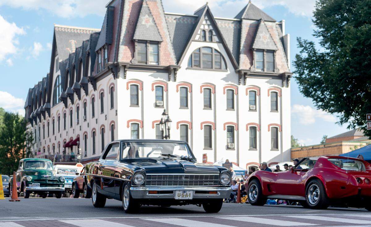 Cars cruise Allegheny Street as people like the sidewalks for the Bellefonte Cruise on Friday, June 17, 2022.