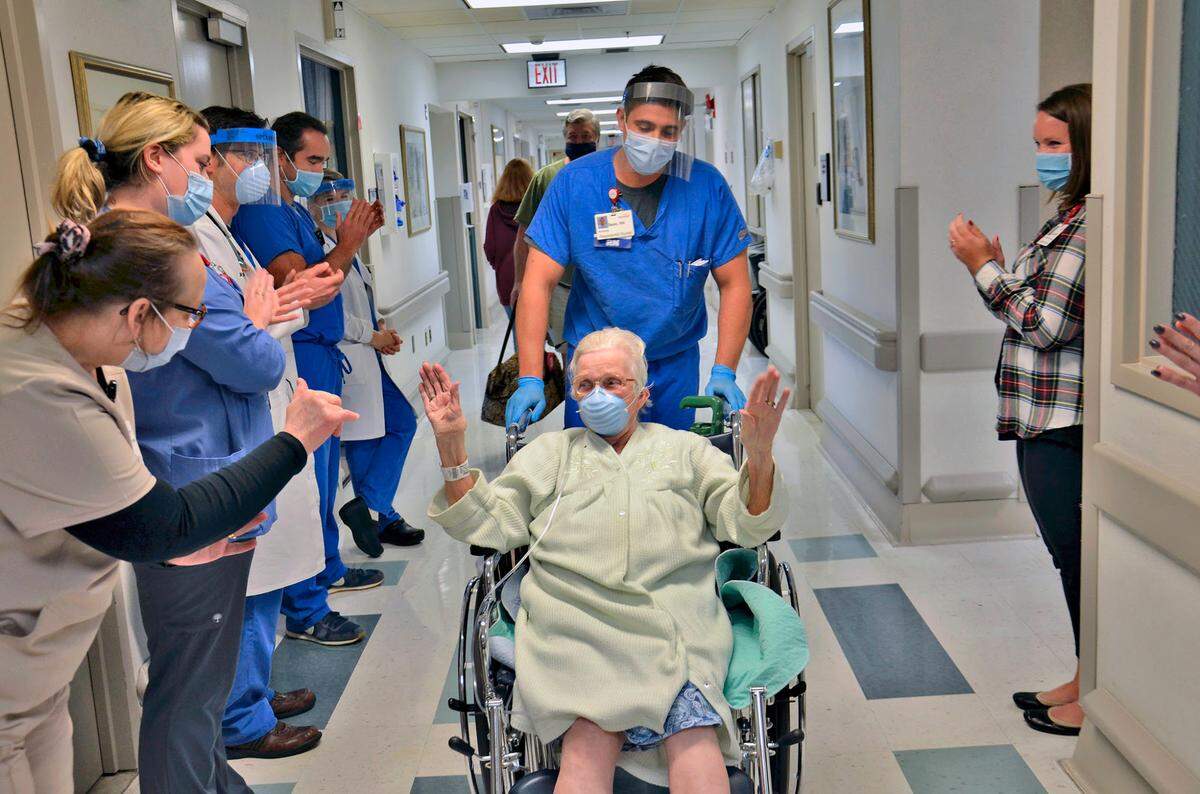Mount Nittany Medical Center staff cheer on Betty Knouse, 89, of Port Matilda, as she is discharged on Sept. 30 after spending more than 30 days hospitalized with COVID-19.