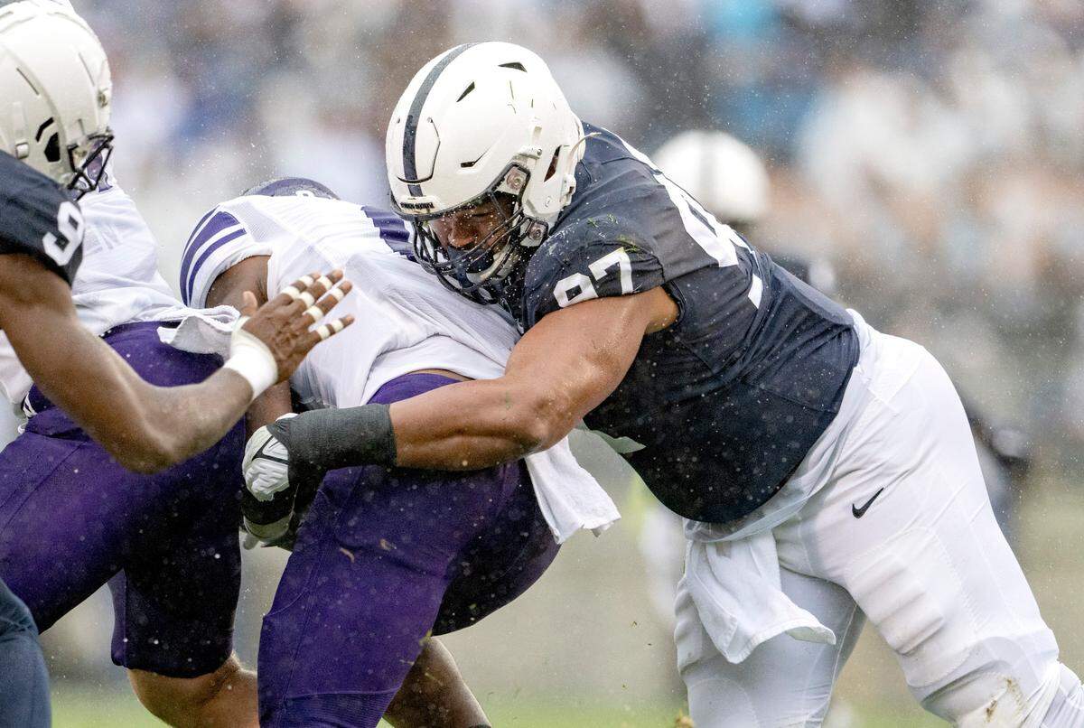 Penn State defensive tackle PJ Mustipher stops Northwestern’s ball carrier during the game on Saturday, Oct. 1, 2022.