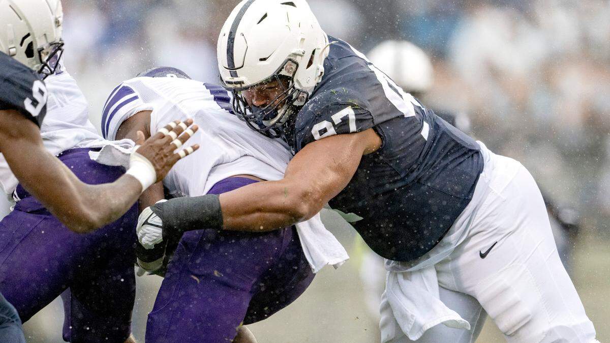 Penn State defensive tackle PJ Mustipher stops Northwestern’s ball carrier during the game on Saturday, Oct. 1, 2022.